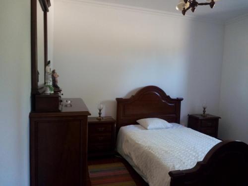 a bedroom with a bed and a dresser and a mirror at Quinta da Abrunheira - Gustavo Eiffel in Ciborro