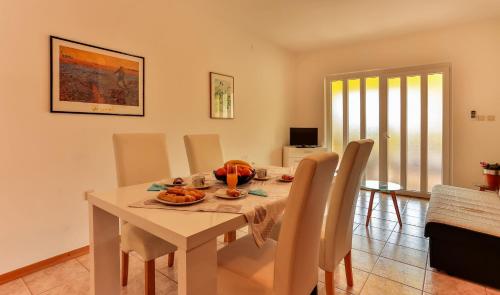 a dining room with a white table and chairs at Apartments Dora Victoria Dream in Medulin