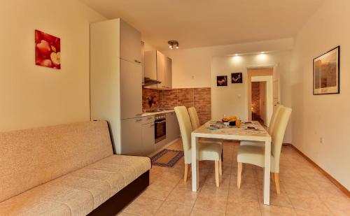 a living room with a table and a couch at Apartments Dora Victoria Dream in Medulin