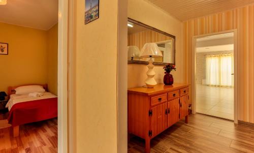 a bedroom with a bed and a dresser and a mirror at Apartments Dora Victoria Dream in Medulin