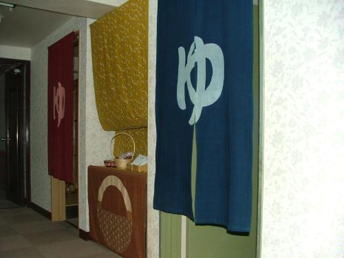 a hallway with a flag with a symbol on it at Miyajima Hotel New Kotobuki in Miyajima