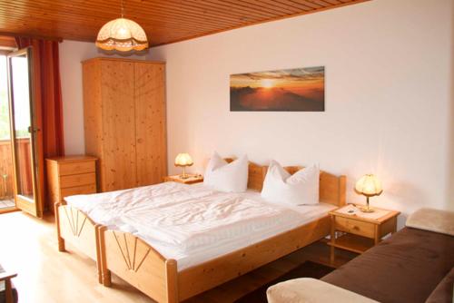 a bedroom with a large bed and two tables with lamps at Haslbauer in Steinbach am Attersee