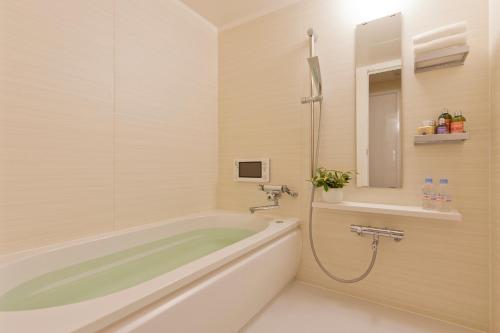 a bath tub sitting next to a bath tub sink at Hotel BIX in Tokyo