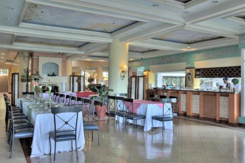 a dining room with tables and chairs and a bar at Hotel Elizabeth - Baguio in Baguio