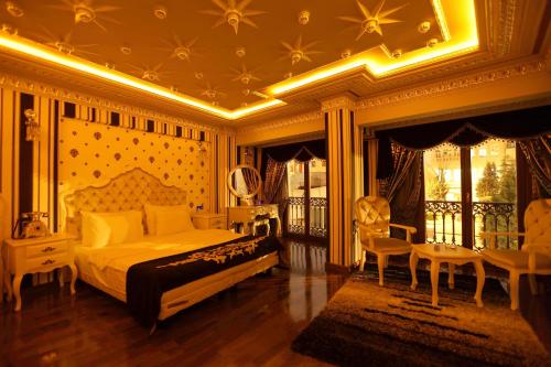 a bedroom with a bed and a table and chairs at Deluxe Golden Horn Sultanahmet Hotel in Istanbul