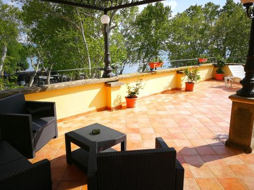 a patio with chairs and a table on a patio at Hotel Royal in Bolsena