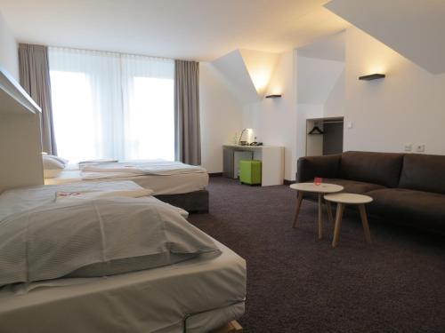 Postel nebo postele na pokoji v ubytování Comfor Hotel Ulm City