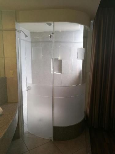a shower in a bathroom with a glass door at Hotel Paraiso in Mexico City