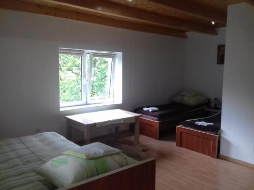 a bedroom with a bed and a desk and a window at Agroturystyka Tylmanowa in Tylmanowa