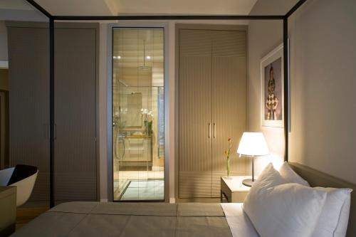 a bedroom with a bed and a sliding glass door at Escalus Luxury Suites Verona in Verona