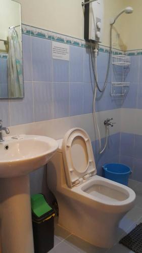 a bathroom with a toilet and a sink at Oslob Malonzo Pension House in Oslob