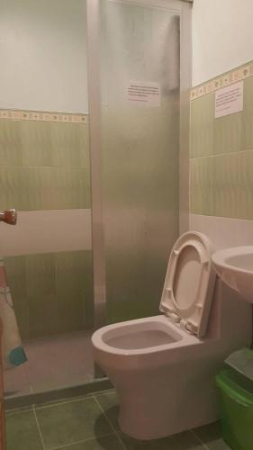 a bathroom with a toilet and a sink at Oslob Malonzo Pension House in Oslob