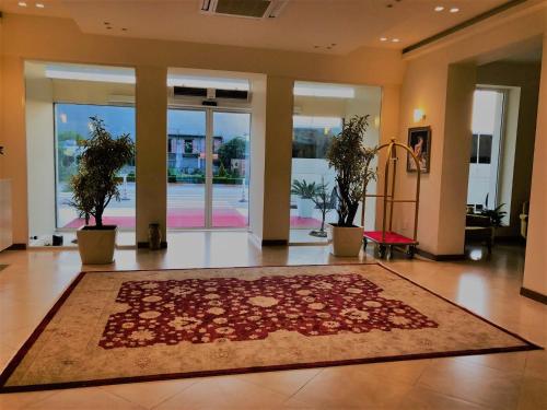 a lobby with a large rug on the floor at Grand White City Hotel in Berat