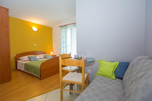 a bedroom with a bed and a desk and a table at Ivan Apartment in Makarska