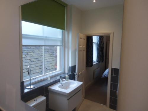 a bathroom with a sink and a window at Hunter’s Retreat in York