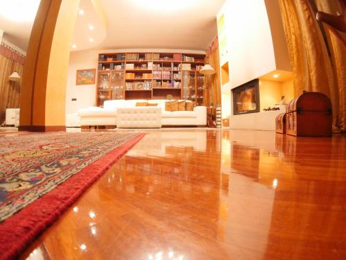 a living room with a hard wood floor and a couch at Villa Roberta in Paderno Dugnano