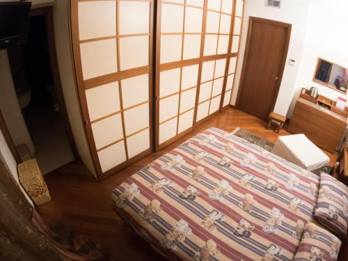 a bedroom with a bed in a room at Villa Roberta in Paderno Dugnano