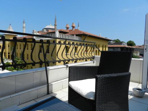 a balcony with two chairs and a yellow fence at Guest House - Grandma's House in Istanbul