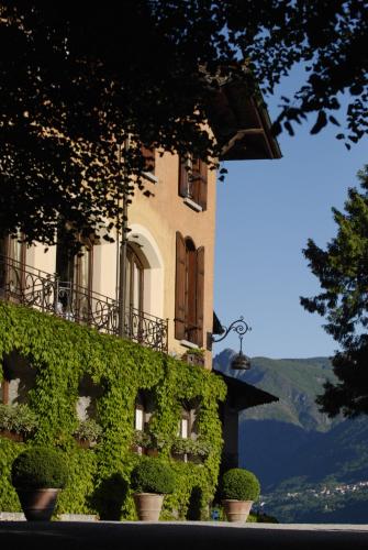 a building with plants on the side of it at The Golf Club Guest House in Menaggio
