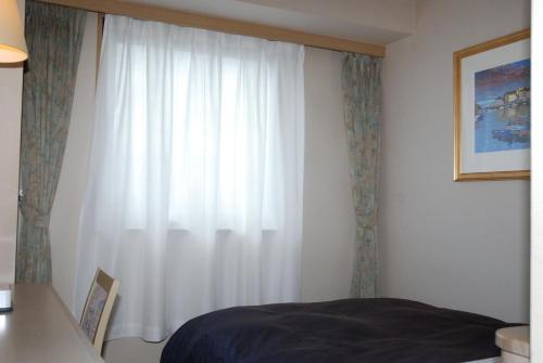 Postel nebo postele na pokoji v ubytování Albert Hotel Akita