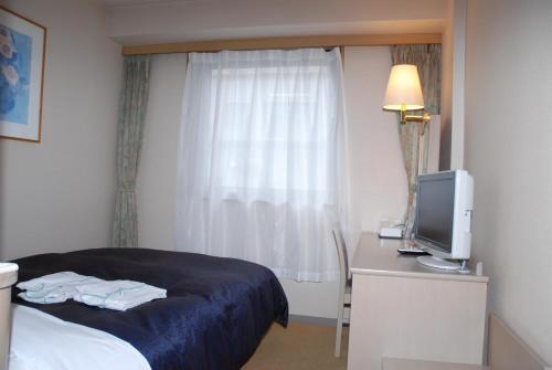 Postel nebo postele na pokoji v ubytování Albert Hotel Akita