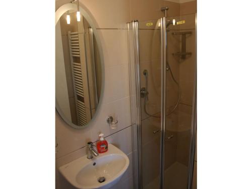 a bathroom with a sink and a shower with a mirror at Apartment Imma in Tremosine Sul Garda