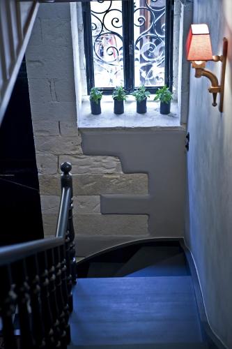 a stairway with potted plants in a window at Mosaic Venetian Harbour Suites in Chania Town