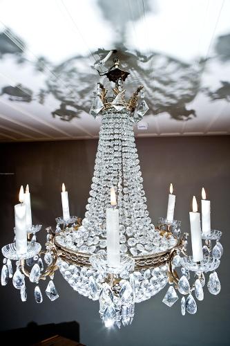 a chandelier hanging from a ceiling with candles at Mosaic Venetian Harbour Suites in Chania Town