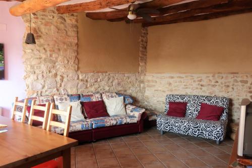 a living room with a couch and a table at Casa Celestino in Alquézar