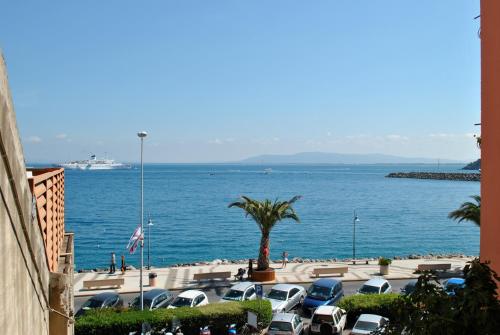 a parking lot with cars parked next to the ocean at Villa Lory Albinia in Albinia