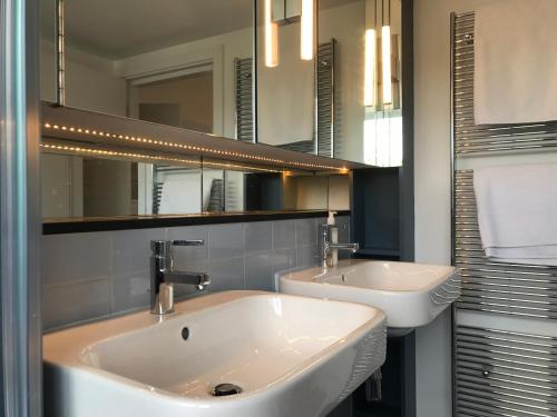 a bathroom with two sinks and a mirror at Camden Town House in London
