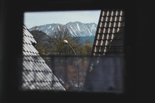 a window with a view of a snowy mountain at Przy Szlaku Zakopane centrum pokoje & apartamenty in Zakopane