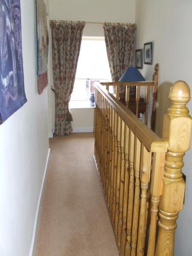 a hallway with a staircase and a window at Inglenook in Kinsale