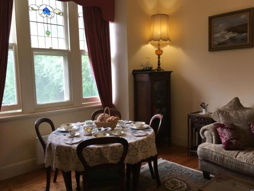 a dining room with a table with dishes on it at Summerhill Farm B&B in Main Ridge