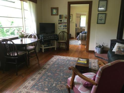 a living room with a table and chairs and a dining room at Summerhill Farm B&B in Main Ridge