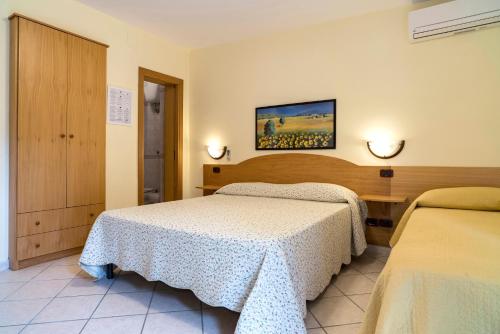 Postel nebo postele na pokoji v ubytování Hotel Ristorante Colleverde