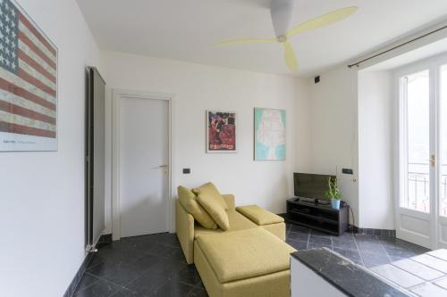 a living room with a couch and a television at Lovely Apartment Overlooking Lake Como by Rent All Como in Carate Urio