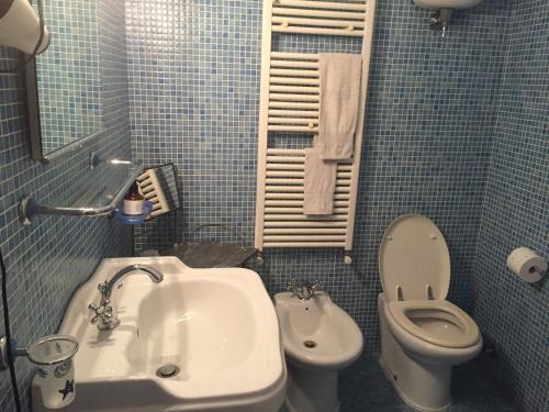 a small bathroom with a sink and a toilet at Casa Fornaciari in Viareggio