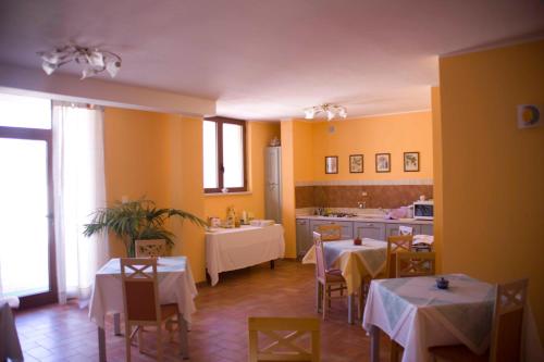 a restaurant with tables and chairs and a kitchen at B&B Sole Luna in Perugia