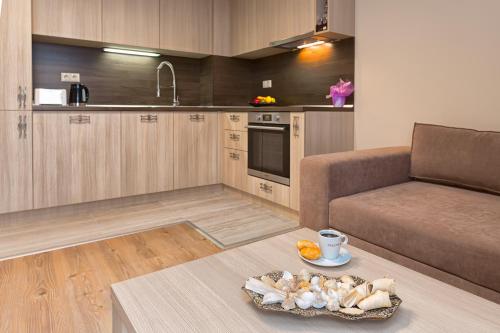 a living room with a couch and a table at Argisht Partez Hotel ALL INCLUSIVE and beach with free sunbeds on the pool & beach bar Rebls in Golden Sands
