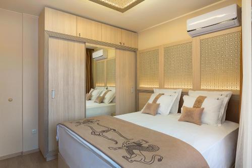a bedroom with a large bed with white sheets and pillows at Argisht Partez Hotel ALL INCLUSIVE and beach with free sunbeds on the pool & beach bar Rebls in Golden Sands