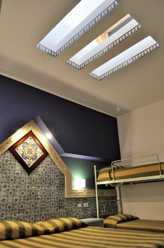 a bedroom with a bunk bed and two skylights at Al-Tair in San Vito lo Capo