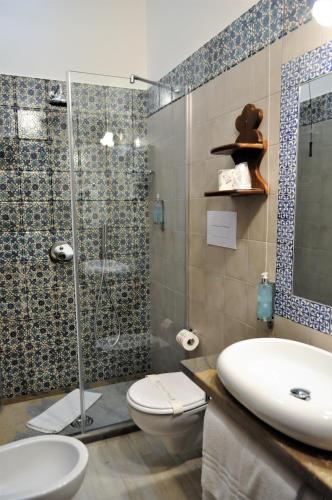 a bathroom with a shower and a toilet and a sink at Al-Tair in San Vito lo Capo