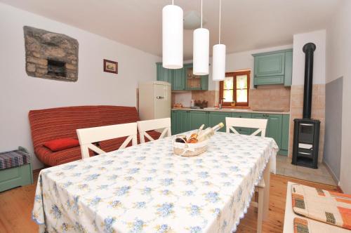 a kitchen and dining room with a table and chairs at Apartments Tonkli in Logje