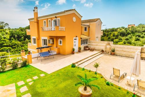 an image of a house with a backyard at Villa Miranda in Gouvia