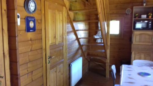 a room with a staircase in a wooden cabin at Chalet Domaine du Hulobiet in Fromelennes
