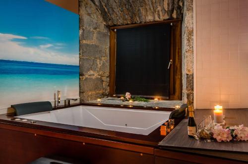 a bath tub in a room with a view of the ocean at Hotel Balneario Orduña Plaza in Orduña