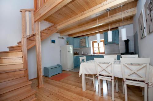 a kitchen and dining room with a table and chairs at Apartments Tonkli in Logje