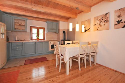 a kitchen with a table and chairs in a room at Apartments Tonkli in Logje