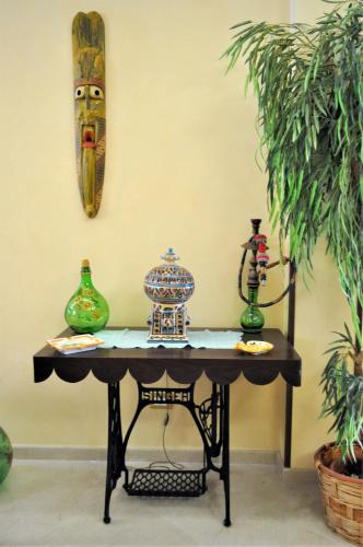 a table with two vases on top of it at Al-Tair in San Vito lo Capo